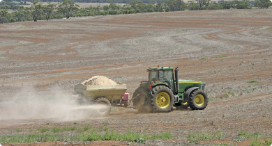 Surface application of agricultural lime using a tow-behind spreader 