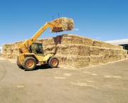 Image of a telly lifter stacking large export square hay bale