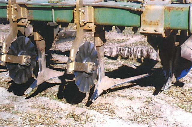 Close photograph of renovation tool with wavy coulters and ripper shanks with mulch sweeps