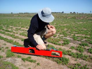 photograph of a person using the EM38 to estimate salinity level in a paddock