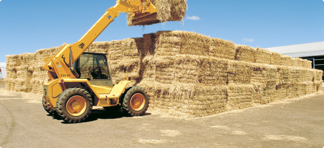 Image of a telly lifter stacking large export square hay bale
