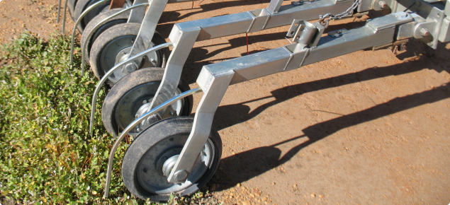 Seeder press wheels with setup for banding wetting agents