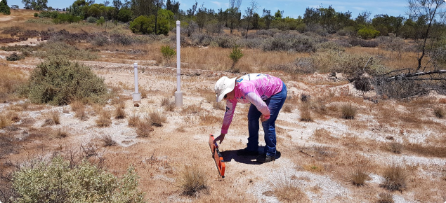Photograph of a person using an EM38 to estimate soil salinity levels