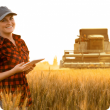 Female grain farmer with smart device