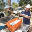 Russell Speed looking at drill cuttings