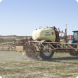 Boom sprayers are pulled by a tractor to spray large areas of land 